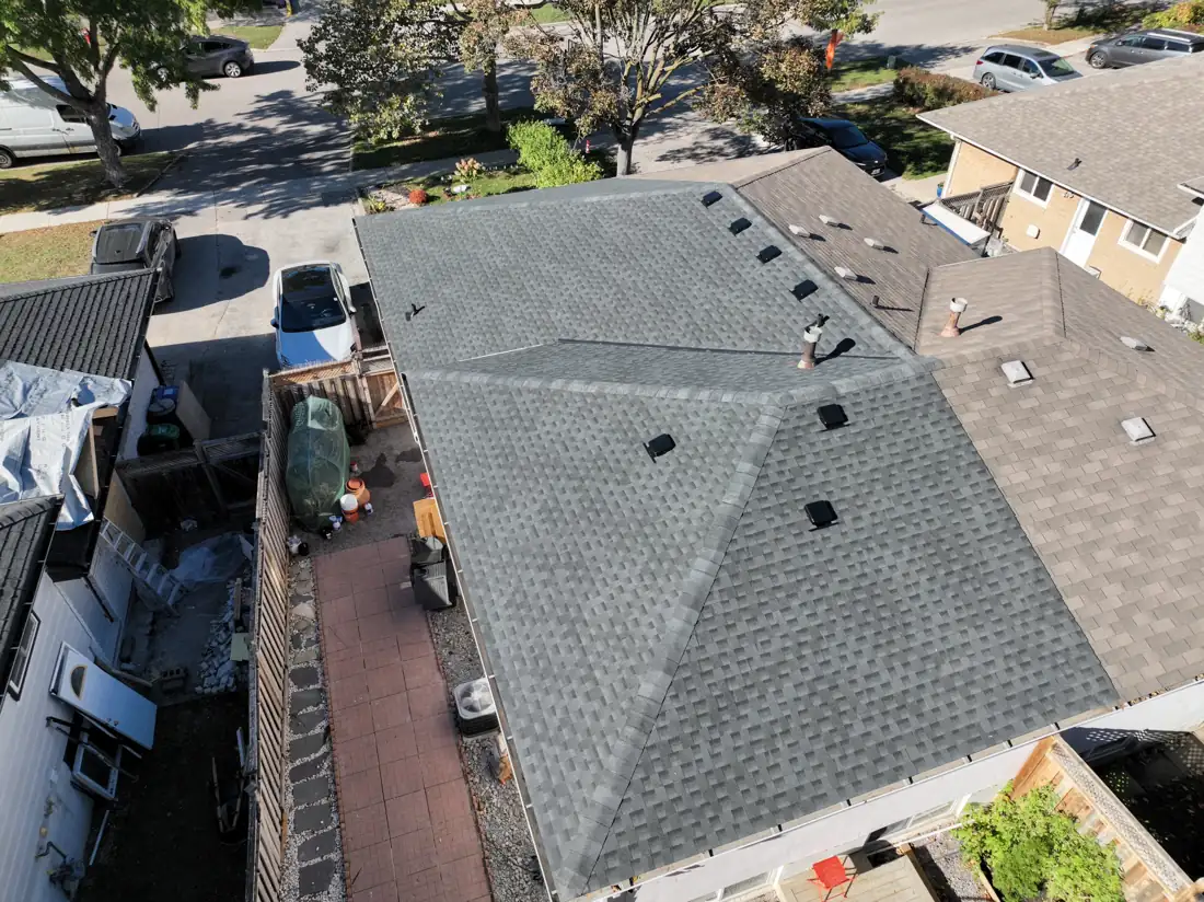 Overhead drone shot of the new grey shingle roof on the Bonnymede Drive home in Mississauga, with even shingle courses and new box vents