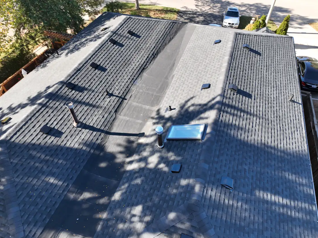 Aerial view of the new shingles, vents and skylight on the completed Bonnymede Drive roof in Mississauga